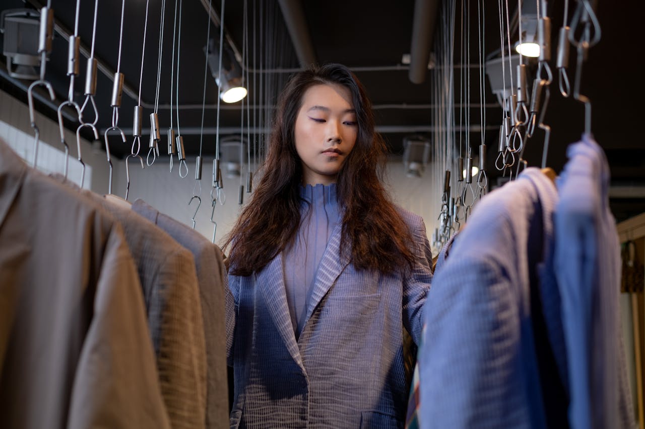 services-01 A stylish young woman browsing clothing options in a chic boutique.